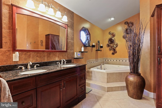 full bath with a bath, tile patterned flooring, double vanity, and a sink