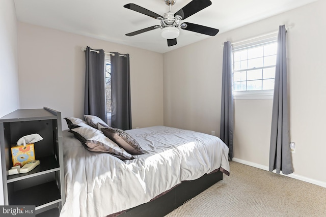 carpeted bedroom featuring a ceiling fan and baseboards