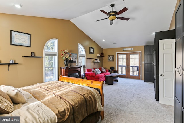 bedroom featuring french doors, light carpet, a fireplace, and multiple windows