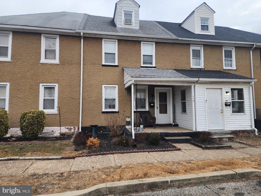 townhome / multi-family property featuring covered porch