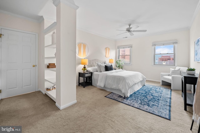 carpeted bedroom with a ceiling fan, baseboards, and crown molding