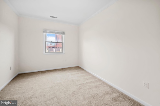 unfurnished room featuring carpet flooring, crown molding, visible vents, and baseboards