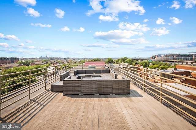 deck with a view of city and an outdoor hangout area