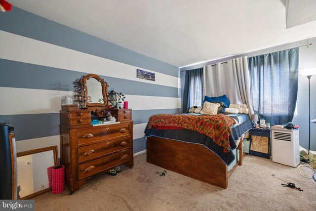 carpeted bedroom with vaulted ceiling