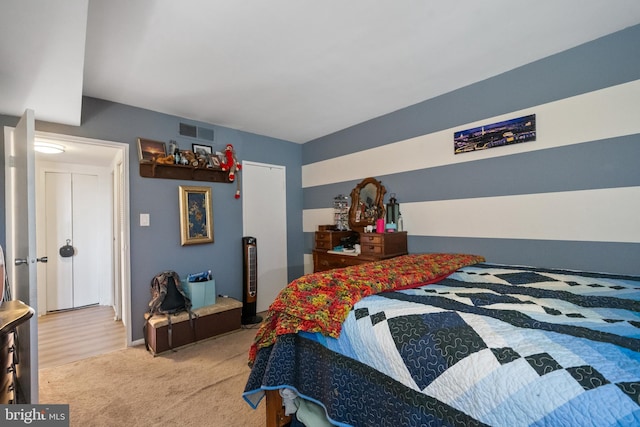 bedroom featuring light carpet and visible vents