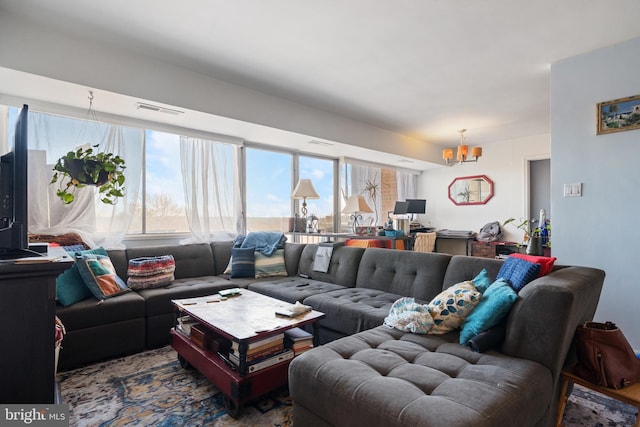 living room with visible vents and a chandelier