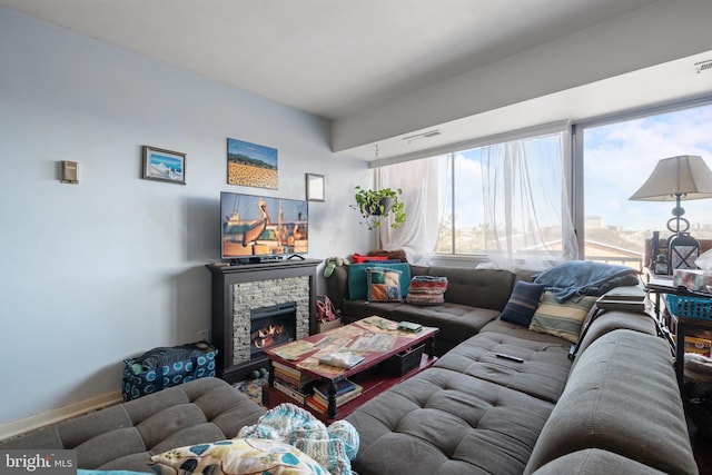 living area with a fireplace and visible vents