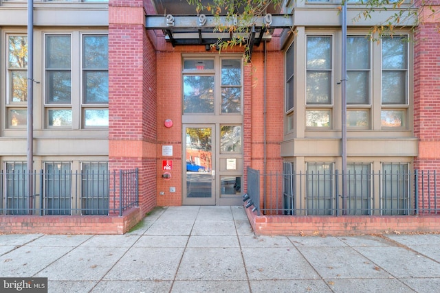 doorway to property with brick siding