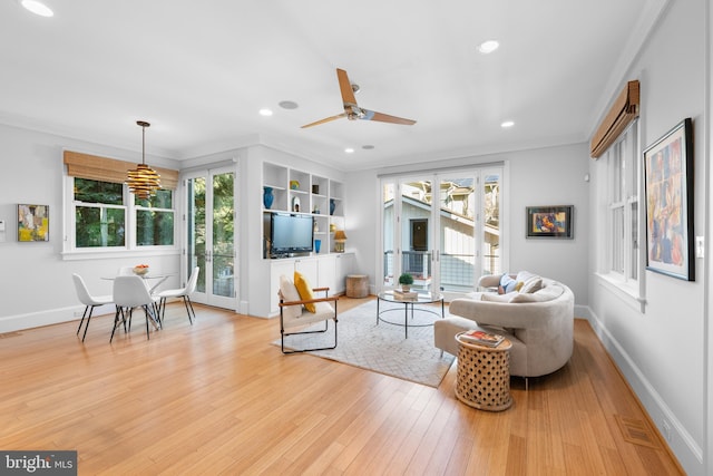 living room with recessed lighting, visible vents, baseboards, and wood finished floors