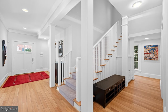 entryway with stairs, plenty of natural light, and wood finished floors