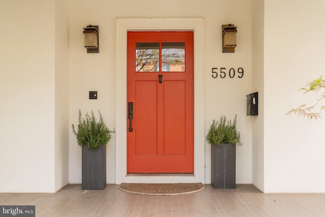 entrance to property featuring stucco siding