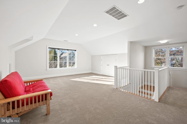 interior space with baseboards, visible vents, lofted ceiling, carpet flooring, and recessed lighting