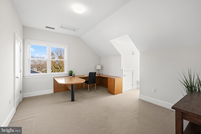 carpeted office space with visible vents, vaulted ceiling, and baseboards