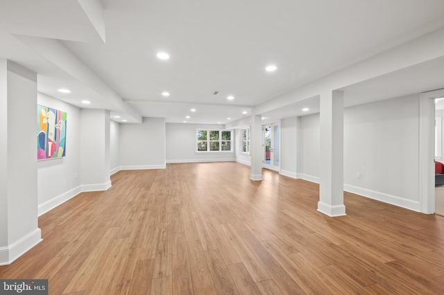 below grade area featuring light wood-type flooring, recessed lighting, and baseboards