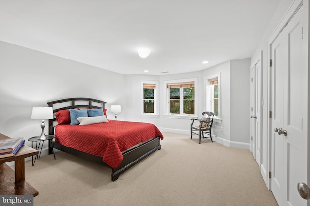 carpeted bedroom featuring recessed lighting and baseboards