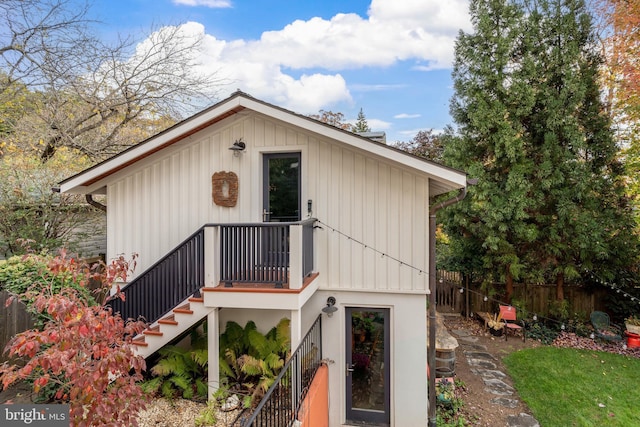 view of front of home featuring fence and stairway