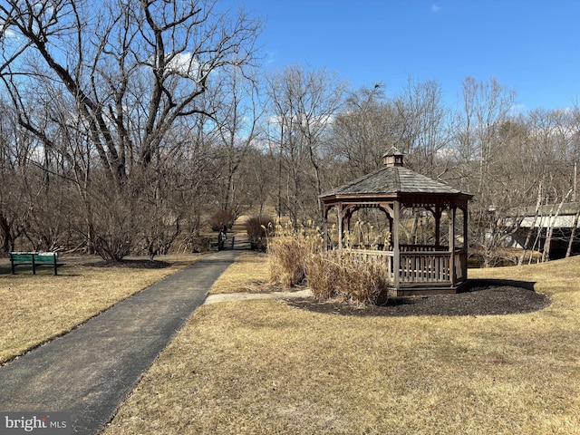 exterior space featuring a lawn and a gazebo