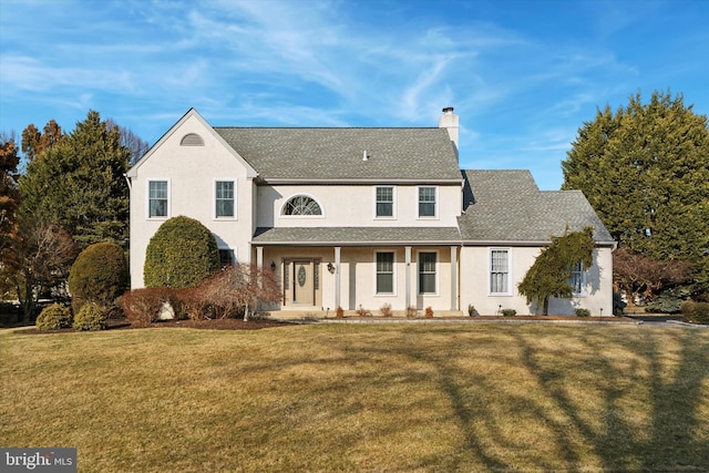 traditional-style home featuring a chimney and a front yard