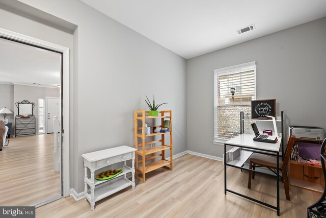 home office with visible vents, baseboards, and wood finished floors