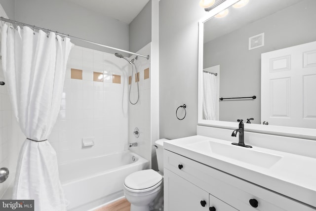 bathroom featuring toilet, visible vents, shower / tub combo with curtain, and vanity