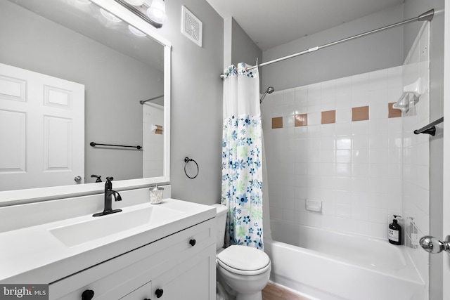 bathroom with shower / bath combination with curtain, visible vents, vanity, and toilet