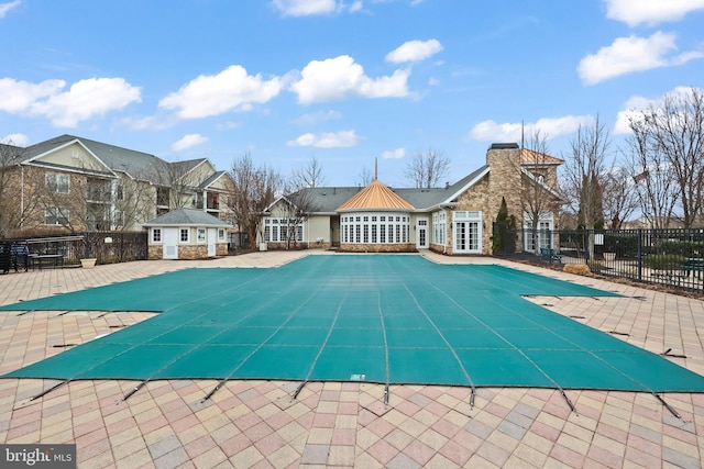 pool with fence and a patio