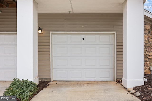 garage featuring concrete driveway