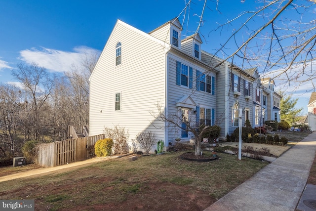 view of side of home featuring a lawn