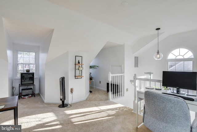 carpeted home office featuring lofted ceiling, visible vents, and baseboards