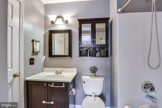 bathroom featuring shower / bath combination, vanity, and toilet