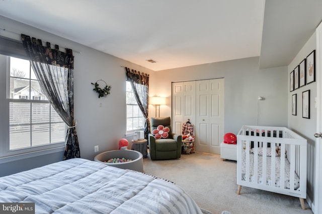 bedroom featuring a closet, carpet, and visible vents