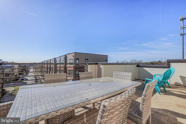 view of patio / terrace with a balcony and outdoor dining space