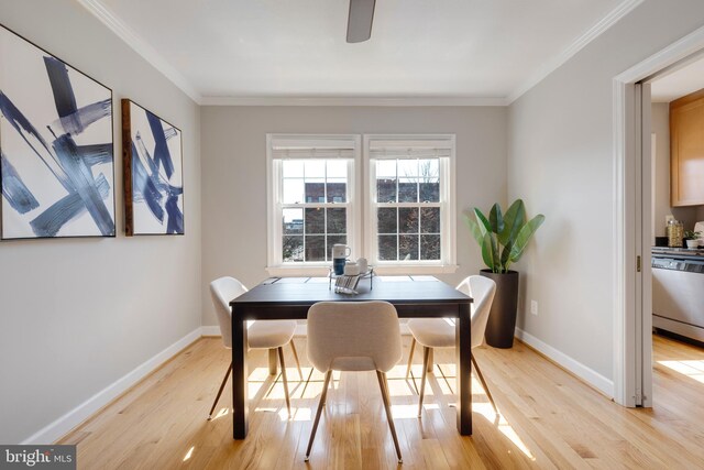 dining room with light wood-style flooring, baseboards, and ornamental molding