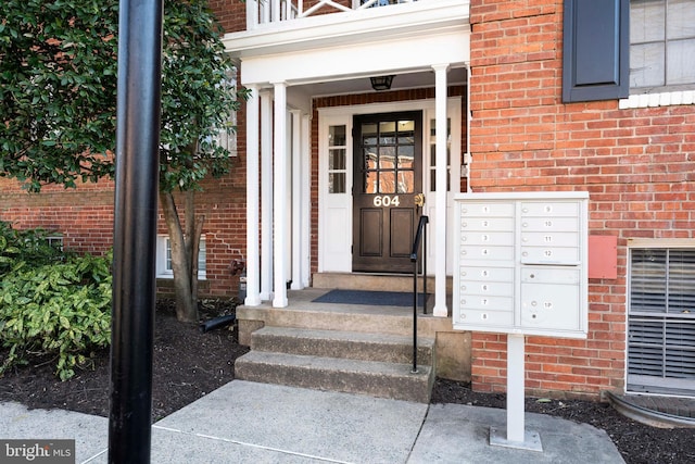 doorway to property with brick siding