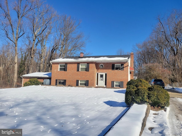 split foyer home featuring a chimney and brick siding