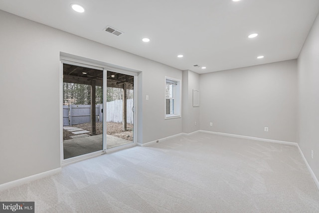 spare room with recessed lighting, visible vents, carpet floors, and baseboards