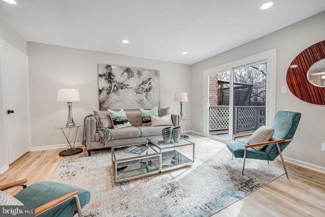 living area with recessed lighting, baseboards, and wood finished floors