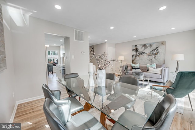 dining room featuring light wood-type flooring, visible vents, baseboards, and recessed lighting