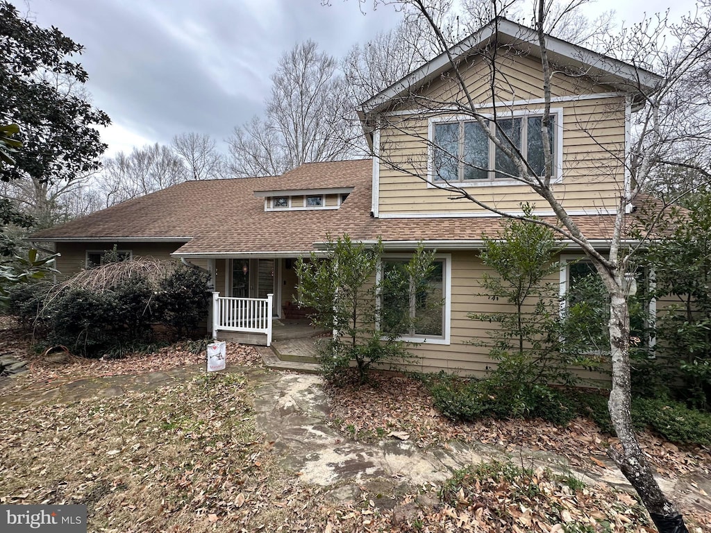 view of front of house featuring covered porch and roof with shingles