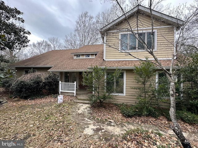 view of front of house featuring covered porch and roof with shingles