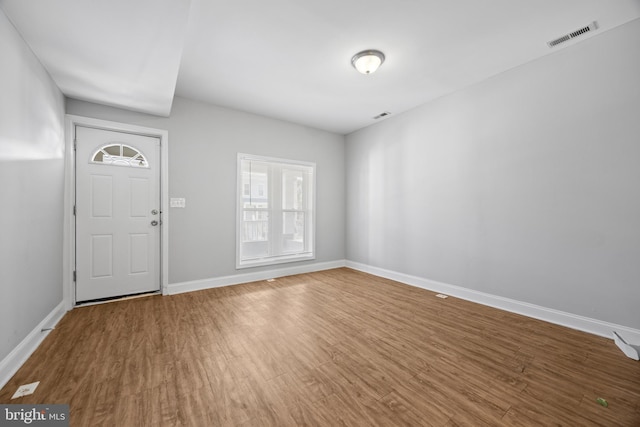 entryway featuring visible vents, baseboards, and wood finished floors