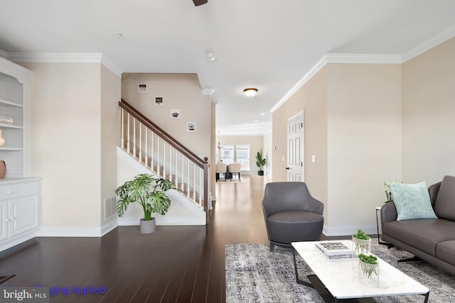 living area featuring visible vents, baseboards, stairs, ornamental molding, and wood-type flooring