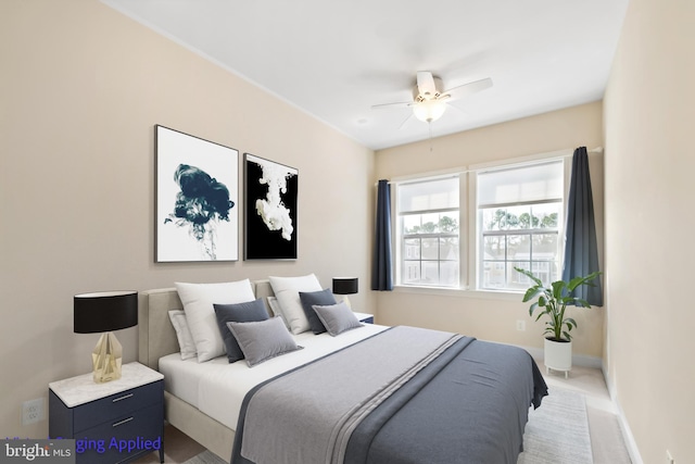 carpeted bedroom with a ceiling fan and baseboards