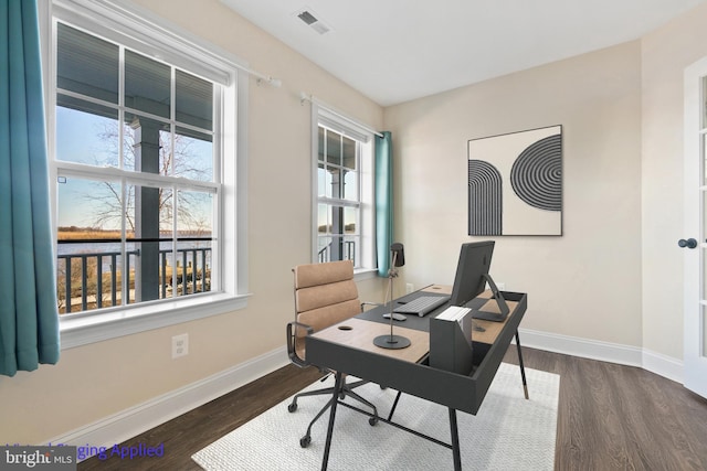 home office with visible vents, baseboards, and dark wood-style flooring