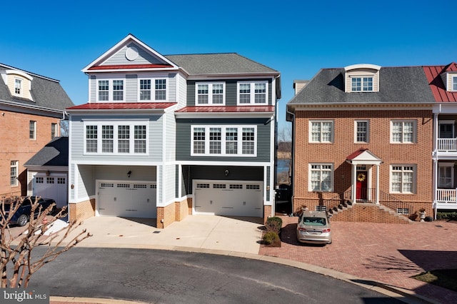 view of front of home with driveway, a standing seam roof, a garage, brick siding, and metal roof