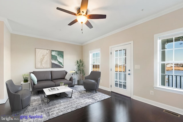 living area featuring plenty of natural light, visible vents, dark wood-style flooring, and ceiling fan