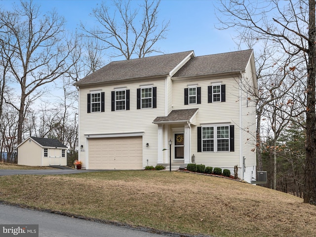 view of front of property with a garage, roof with shingles, aphalt driveway, and a front lawn