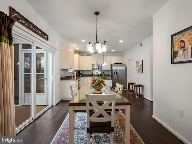 dining space with a notable chandelier, recessed lighting, dark wood-style flooring, visible vents, and baseboards