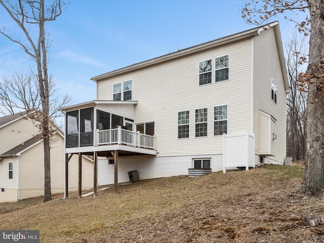 rear view of house featuring a sunroom