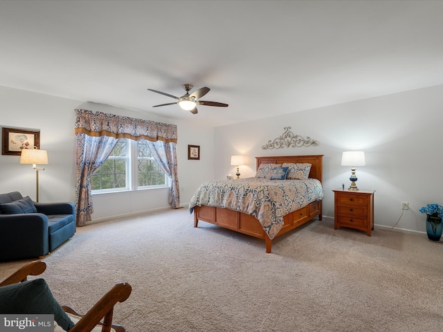 bedroom with light carpet, ceiling fan, and baseboards